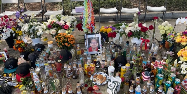 flowers and drinks in honor of a killed member